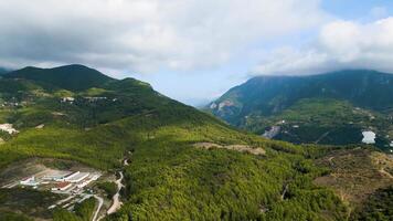 Aerial view of a mountain range with a small town in the middle video
