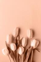 Mocha Mousse - color of the year 2025. Top view of beautiful tulips on brown background photo