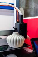 Four heads 3d printer, four extruders with an object on the tray, pla filament, futur photo