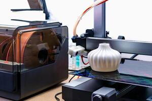 Four heads 3d printer, four extruders with an object on the tray, pla filament, showroom photo