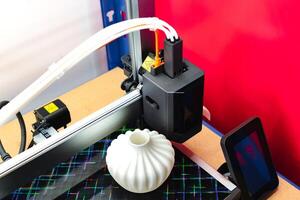 Four heads 3d printer, four extruders with an object on the tray, pla filament, technology photo