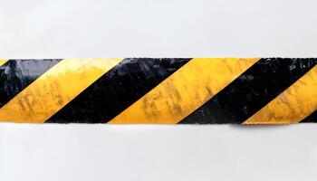 Black and yellow horizontal caution tape isolated on a white background with a soft shadow emphasizing its bold warning pattern ideal for industrial sites construction zones and safety visuals photo