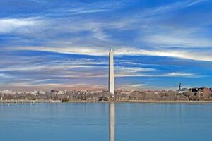 Stunning view of the Washington Monument reflecting in the Tidal Basin under dramatic skies photo