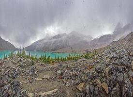 Hiking view near Mt Garibaldi with turquoise lake and dramatic clouds in the mountains- photo