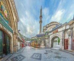 Wide angle view of a bazaar in Istanbul with shops and historic architecture photo