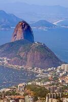 Close-up of Sugarloaf Mountain in Rio de Janeiro with its green slopes and scenic bay photo
