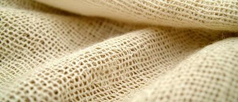 Detailed close-up of soft, natural fabric with intricate weave pattern and texture. photo