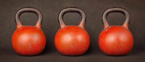 Set of three vibrant kettlebells on a dark background for fitness enthusiasts. photo