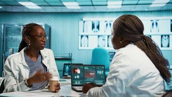Female physician conducting a routine checkup with young patient, analyzing diagnostics and treatment options with radiology scans. Health care data in a professional clinic. Camera B. video