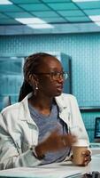 Vertical Female physician conducting a routine checkup with young patient, analyzing diagnostics and treatment options with radiology scans. Health care data in a professional clinic. Camera B. video