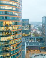 employees workers in office in The Europa Tower is a high-rise located in Vilnius CBD, Lithuania. It is the tallest building in the Baltic states. photo