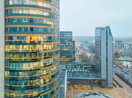 employees workers in office in The Europa Tower is a high-rise located in Vilnius CBD, Lithuania. It is the tallest building in the Baltic states photo