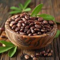 Jojoba seeds in the bowl, healthy food photo, leaves photo