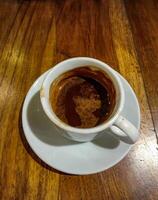 Half an espresso shot is taken from the top photo