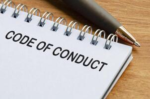 Code of Conduct text on white notepad. Business code of conduct concept photo