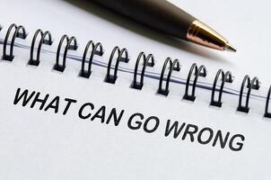 What can go wrong text on white notepad. Business or auditing concept photo