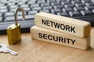 Network Security text on wooden blocks with locker pad and keyboard background photo