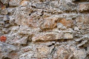 Close-up view of uneven bricks with rough texture photo