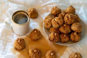 Lots of small nut cookies with whole almonds in the middle. photo