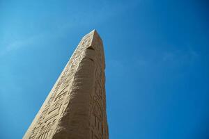 Ancient Egyptian obelisk with hieroglyphs carved on it photo