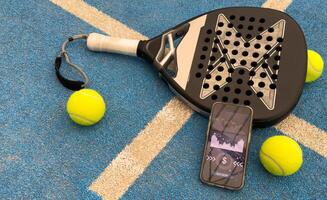 paddel racket and smartphone with bet background photo