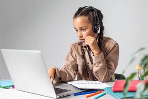 E-Learning. Shocked Little Schoolgirl Looking At Laptop Wearing Headphones Looking At Computer Web Camera In Shock Making Call And Learning Online At Home. Shocking News Concept. photo