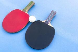 tennis rackets for playing ping pong on blue table, ping pong concept, active sports photo