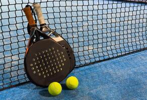 Padel tennis racket. Background with copy space. Sport court and balls. photo