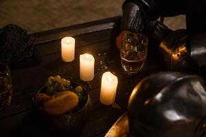 Lanterns on table with beer. candlesticks and beer on a wooden old table. photo