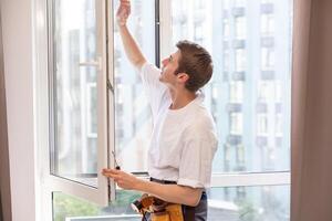 Construction worker installing window in house. photo
