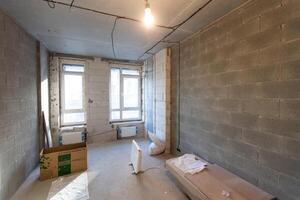 Working process of installing metal frames for plasterboard -drywall - for making gypsum walls in apartment is under construction, remodeling, renovation, extension, restoration and reconstruction photo