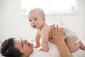 picture of happy mother with baby in hands photo