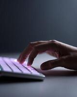 Digital Technology Close up Hand Typing on Glowing Keyboard photo