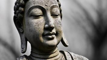 Weathered stone statue with serene expression. photo