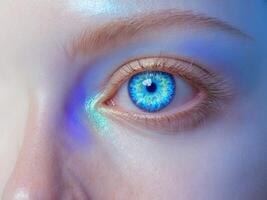Close up of a stunning blue eye showcasing vibrant colors and reflections with ample blank space for text overlay on a soft background. photo