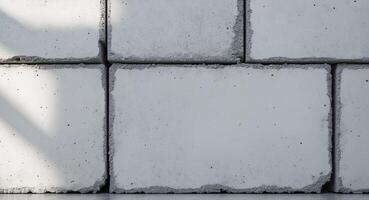 Rough concrete block texture with visible seams and imperfectionsRough concrete block texture with visible seams and imperfections. photo