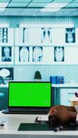 Vertical Doctor and patient discuss about health care recovery next to mockup screen, meeting in cabinet to share advice and medicine. Professional medic consulting girl during routine checkup. Camera B. video