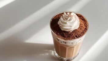 Iced coffee drink layered with cocoa powder topping photo