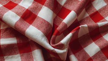 Red and white checkered tablecloth textile texture on a vibrant red background for backgrounds and design projects photo