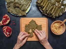 Preparation of Dolma from grape leaves photo