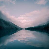 Alpine mystical natural square background with fog early morning. Silhouettes of pointy fir tops on hillside along mountain lake in dense fog. Reflection of coniferous trees in calm water. photo