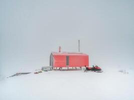 Soft focus. Poor visibility. Red house and a snowmobile on a fog photo