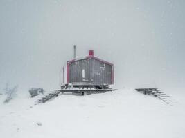 Soft focus. Poor visibility. Lonely house in a snowfall on a fog photo
