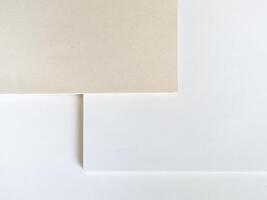 Paper without bleaching in comparison with ordinary white of high quality. White recycled paper background or texture. Import substitution. Flat lay, copy space photo