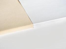 Paper without bleaching in comparison with ordinary white of high quality. White recycled paper background or texture. Import substitution. Flat lay, copy space. photo