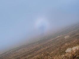 Natural phenomenon - Brocken ghost, also called the mountain ghost, is the shadow of an observer on the surface of clouds in the direction opposite to the sun. photo