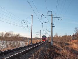 Rustic spring view with a train. Suburban train in motion. Transport logistics, railway transportation. photo