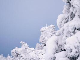 Frozen cross on a rock. Kolchinsky stone, a mountain of the Perm photo