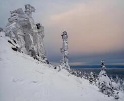 granite rock is frozen and covered with snow. photo