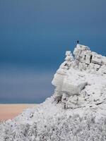 Man on the frozen cliff. photo